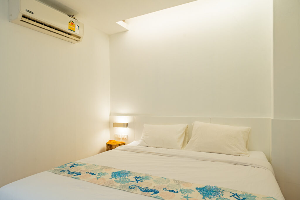 Superior Room at Good Breeze Hostel Phuket — queen bed with refrigerator